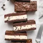 Overhead view of homemade brownie Ice Cream Sandwiches Recipe treats arranged on a white surface