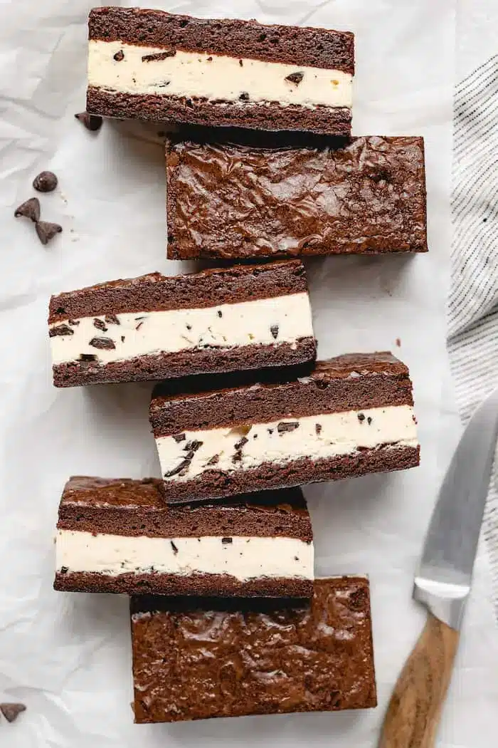 Overhead view of homemade brownie Ice Cream Sandwiches Recipe treats arranged on a white surface