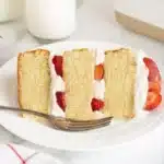 A slice of strawberry shortcake cake ready to enjoy
