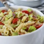 Close-up of pasta salad with romaine, tomatoes, and blue cheese