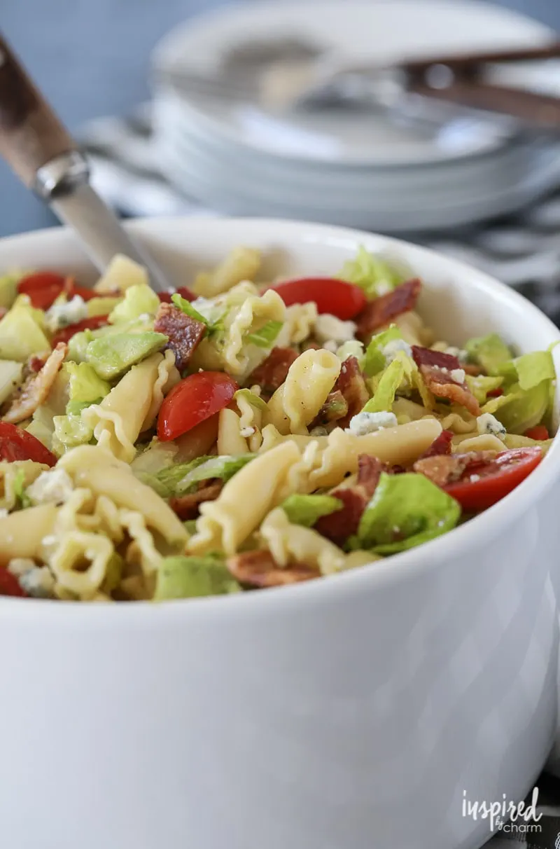 Close-up of pasta salad with romaine, tomatoes, and blue cheese