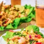 A single serving of shrimp salad with the full salad in the background