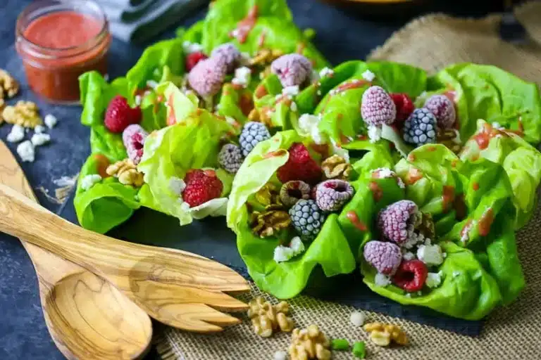 Toasted walnuts and fresh raspberries on a bed of lettuce