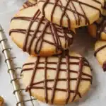 Shortbread Cookie Recipe with chocolate drizzle on a parchment-lined wire rack