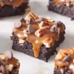 Cut pieces of turtle brownies on a marble surface