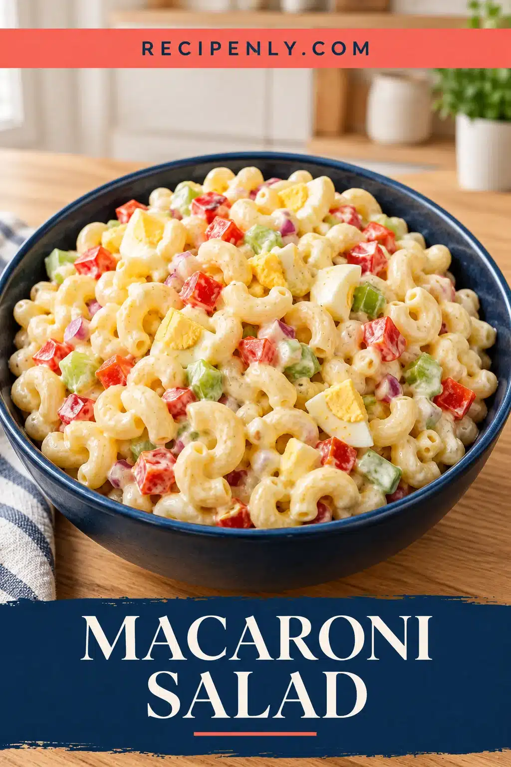 Creamy elbow macaroni salad with colorful vegetables in a navy serving bowl