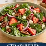 15-Minute Strawberry Spinach Salad 11 Spinach salad with sliced strawberries, pecans, red onion and crumbled white cheese in a pale sage bowl
